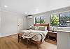 Primary ensuite bedroom with one king bed and private full bathroom – located on upper level (3rd floor).