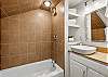 Second ensuite bathroom with a tub and shower combo. 