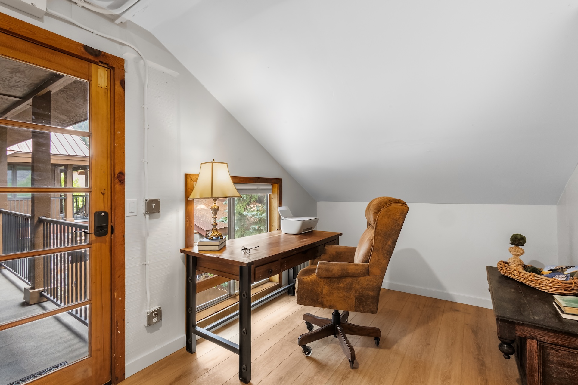 Office area equipped for remote work, with a desk and comfortable seating.