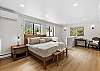 Primary ensuite bedroom with one king bed and private full bathroom – located on upper level (3rd floor).