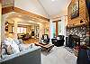 Living room with fireplace and sofa that converts into bed for additional sleeping space. 