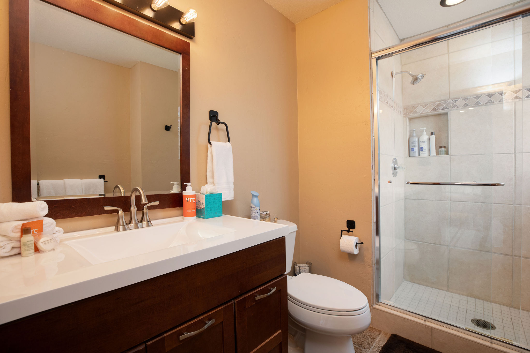 Full bathroom with sleek walk-in shower.