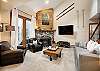 Living room with fireplace and sofa that converts into bed for additional sleeping space. 