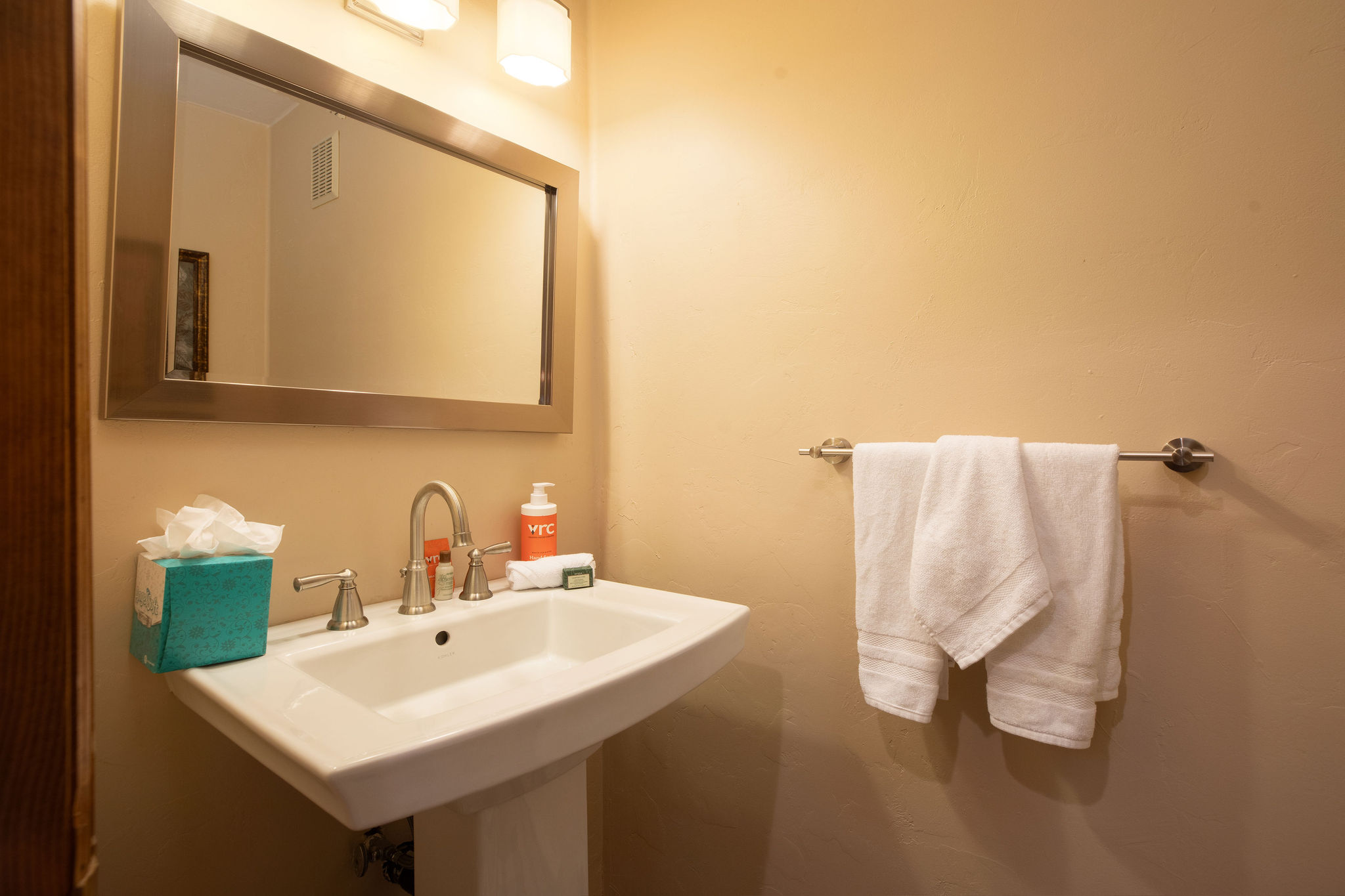 Conveniently located half bath with sink and toilet