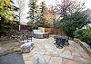 Large patio with outdoor seating and a private hot tub that fits all 12 guests