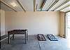 The garage includes a foosball table and corn hole. 