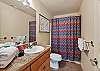 The guest bathroom features a convenient tub/shower combo.