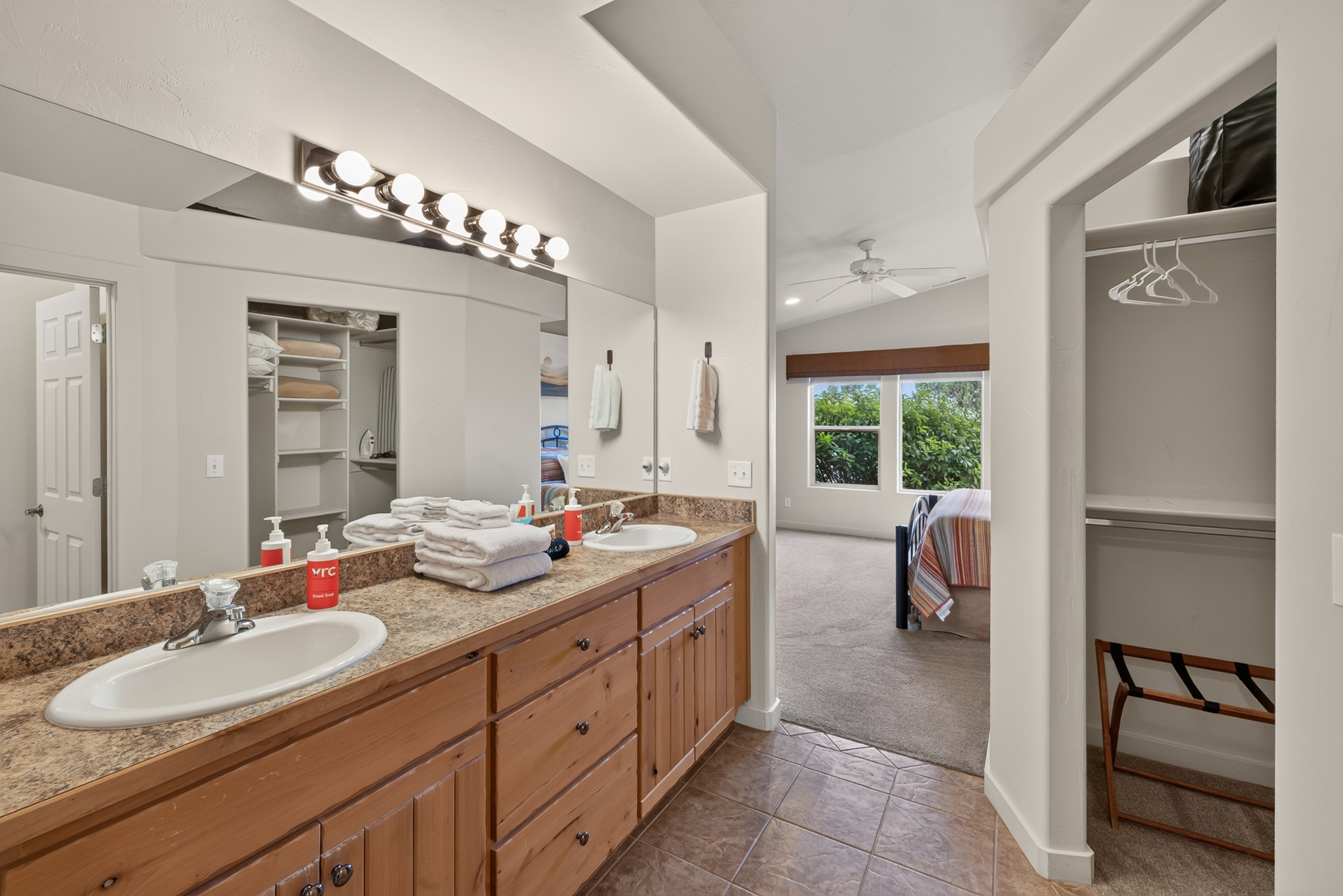 The en suite bathroom features a walk-in shower, dual sinks, and a large closet.