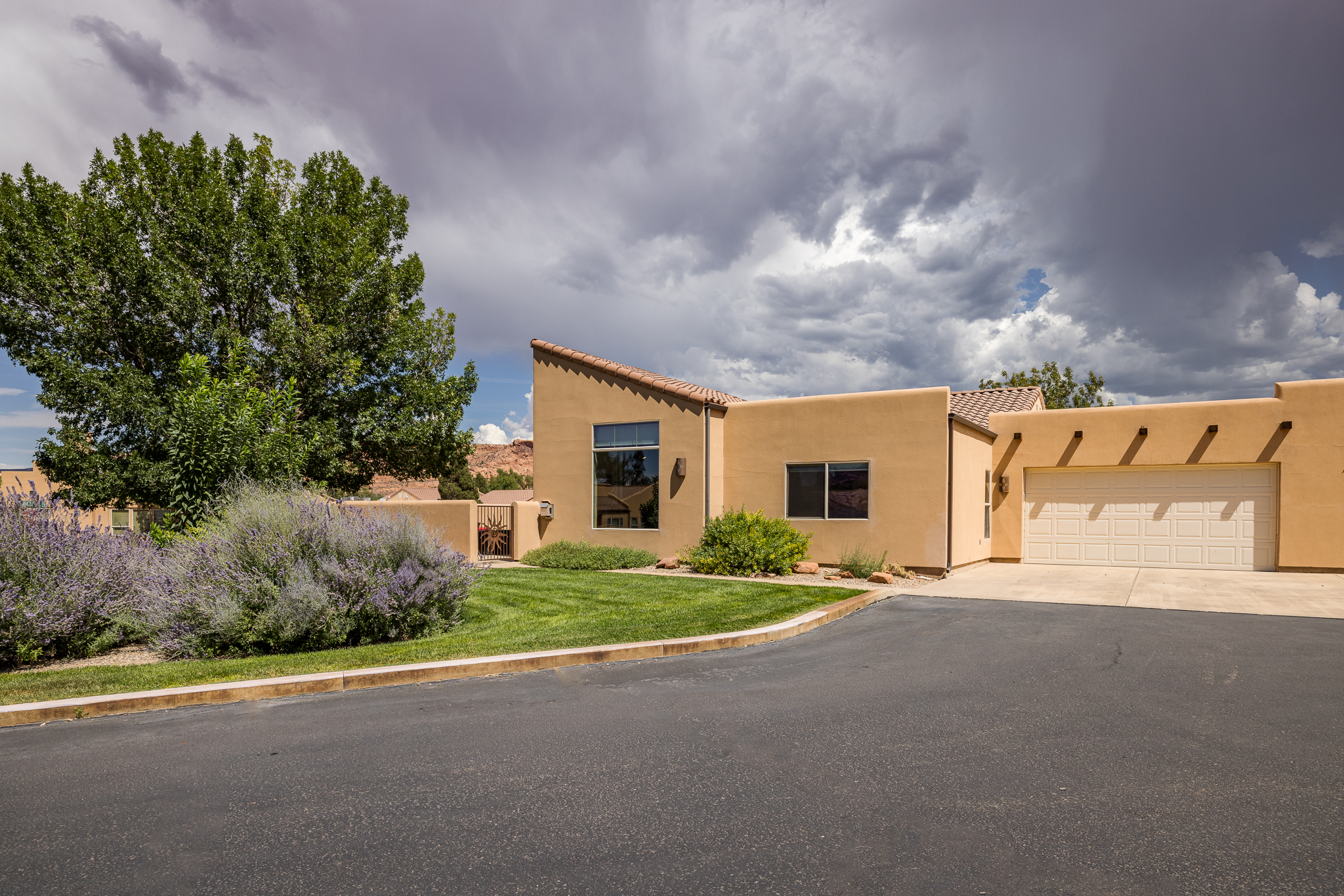 Exterior view of the home + garage and driveway. 
