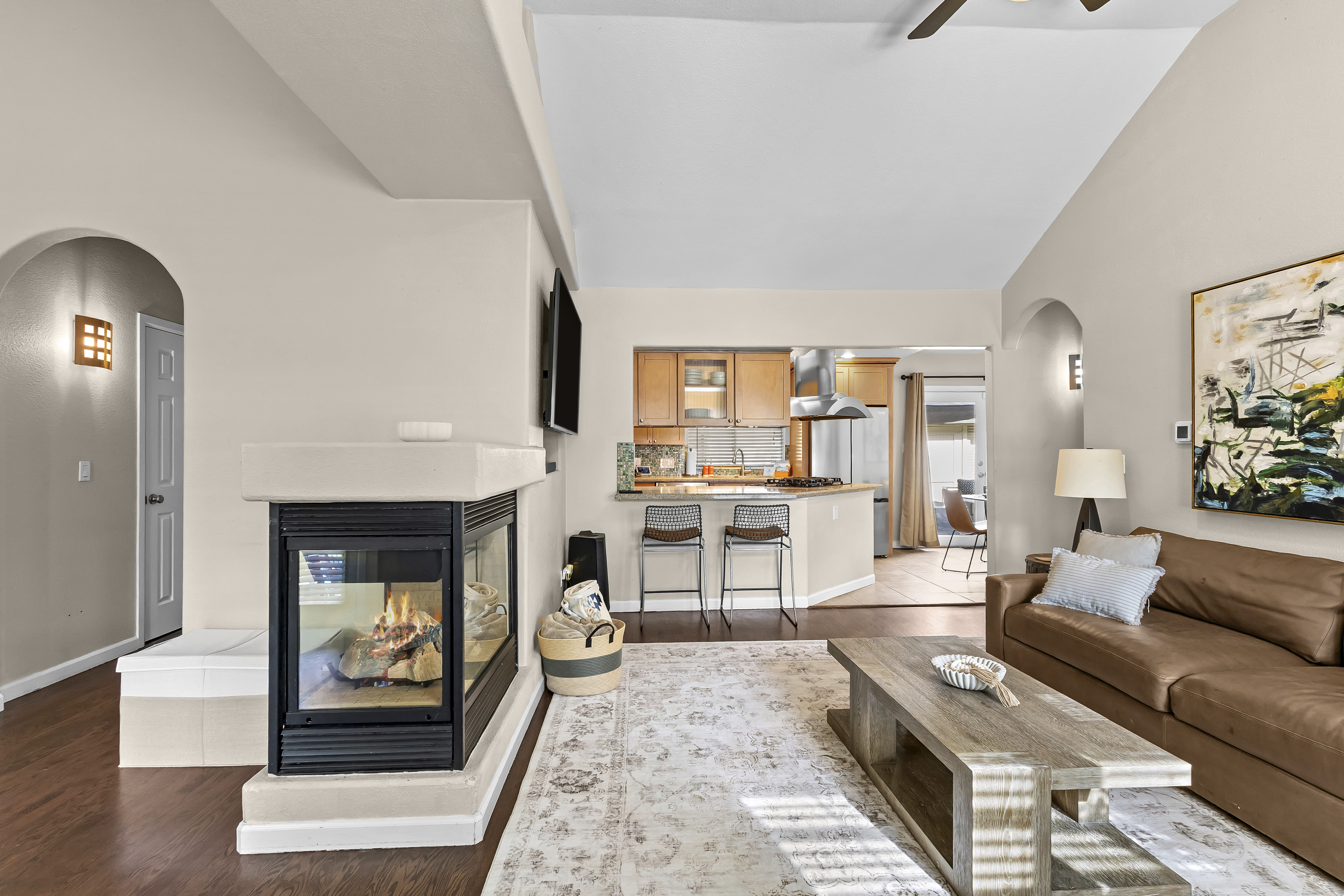 The living room includes a gas fireplace, a smart TV, and plenty of seating. 