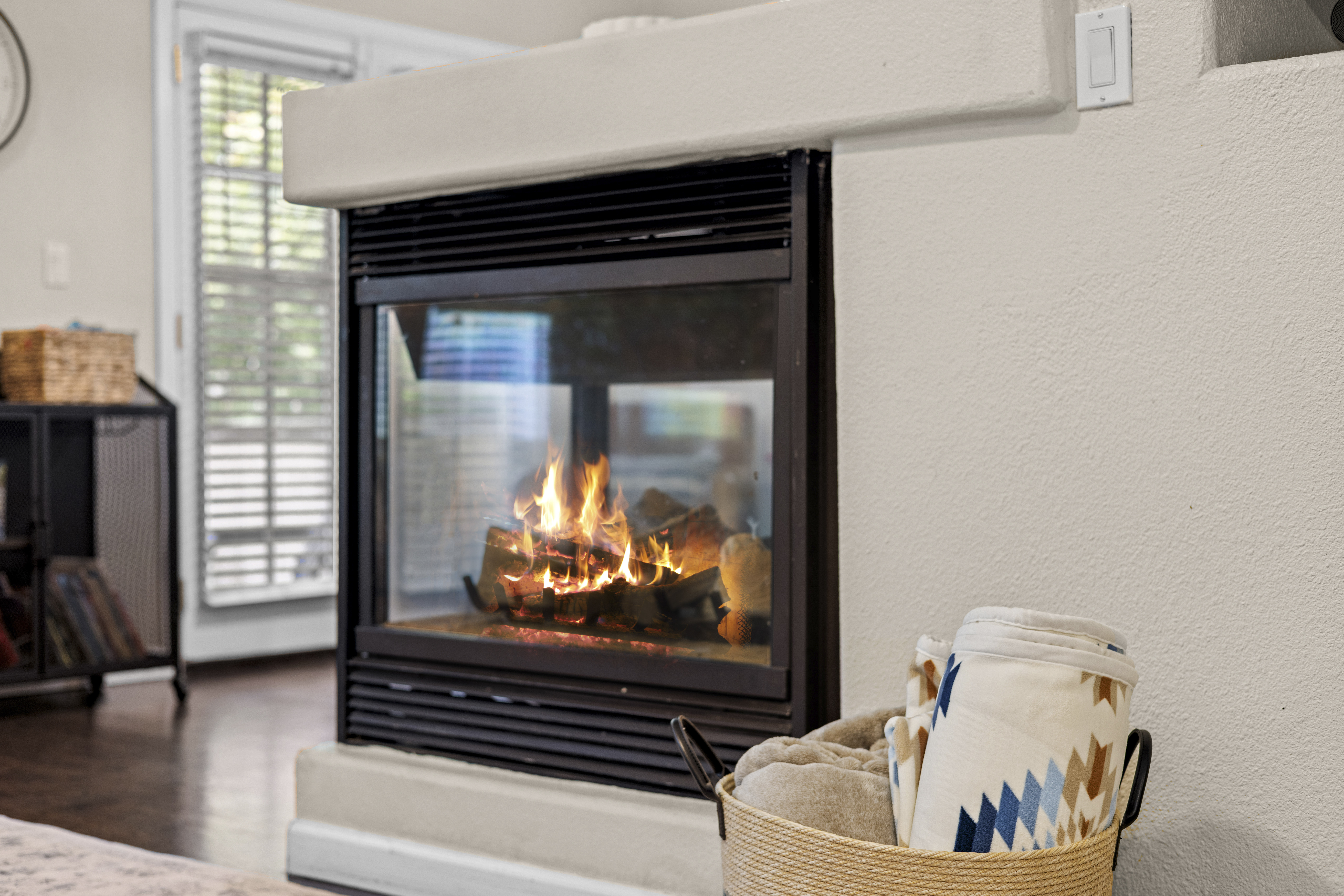The living room includes a gas fireplace, a smart TV, and plenty of seating. 