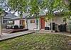 The fully fenced backyard includes a gas grill, patio area, and fire pit. 