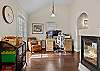 Off to the side of the living room is an office space for remote workers, plus a cabinet with games for the family. 