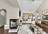 The living room includes a gas fireplace, a smart TV, and plenty of seating. 