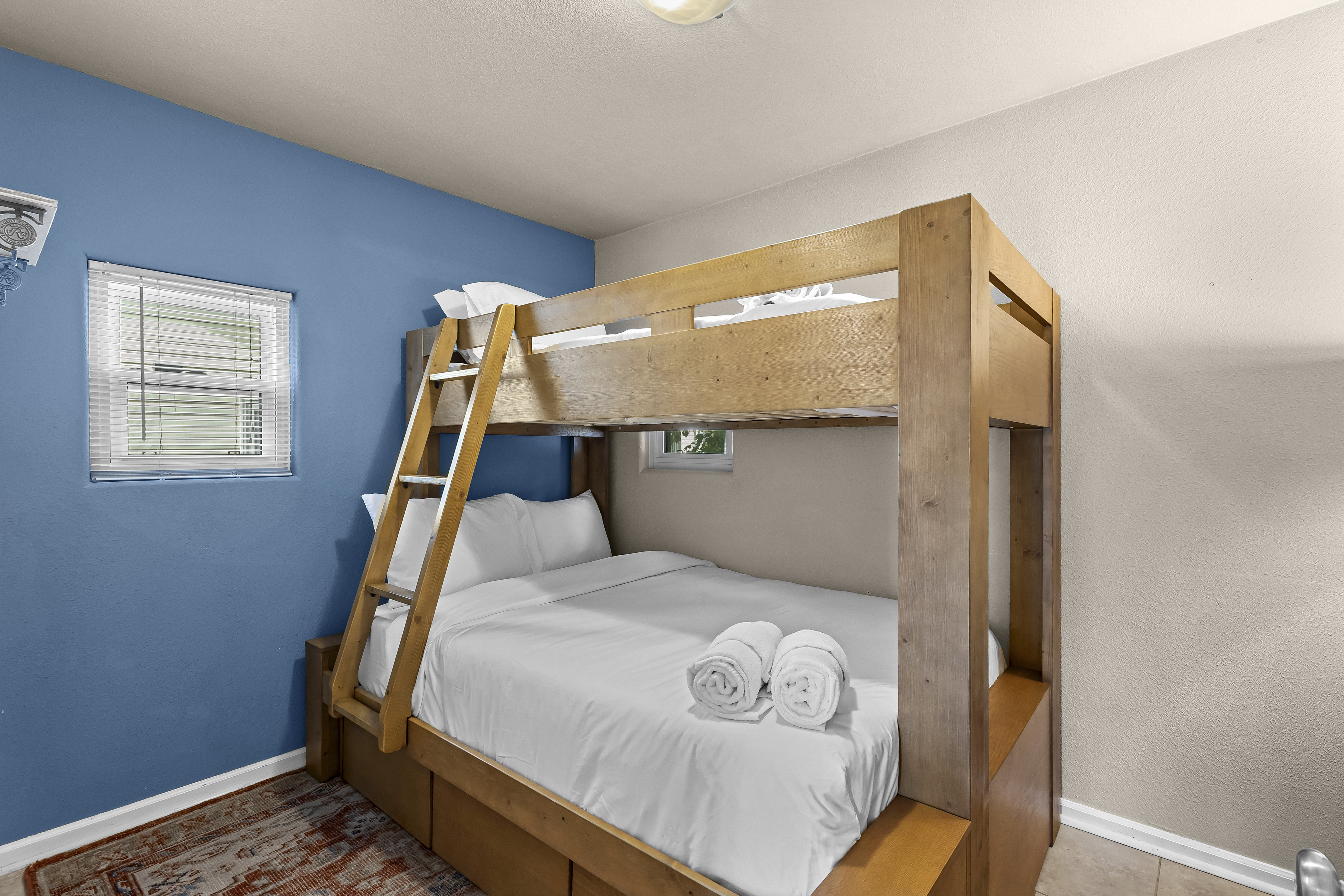 Guest bedroom with a twin-over-full bunk bed. 