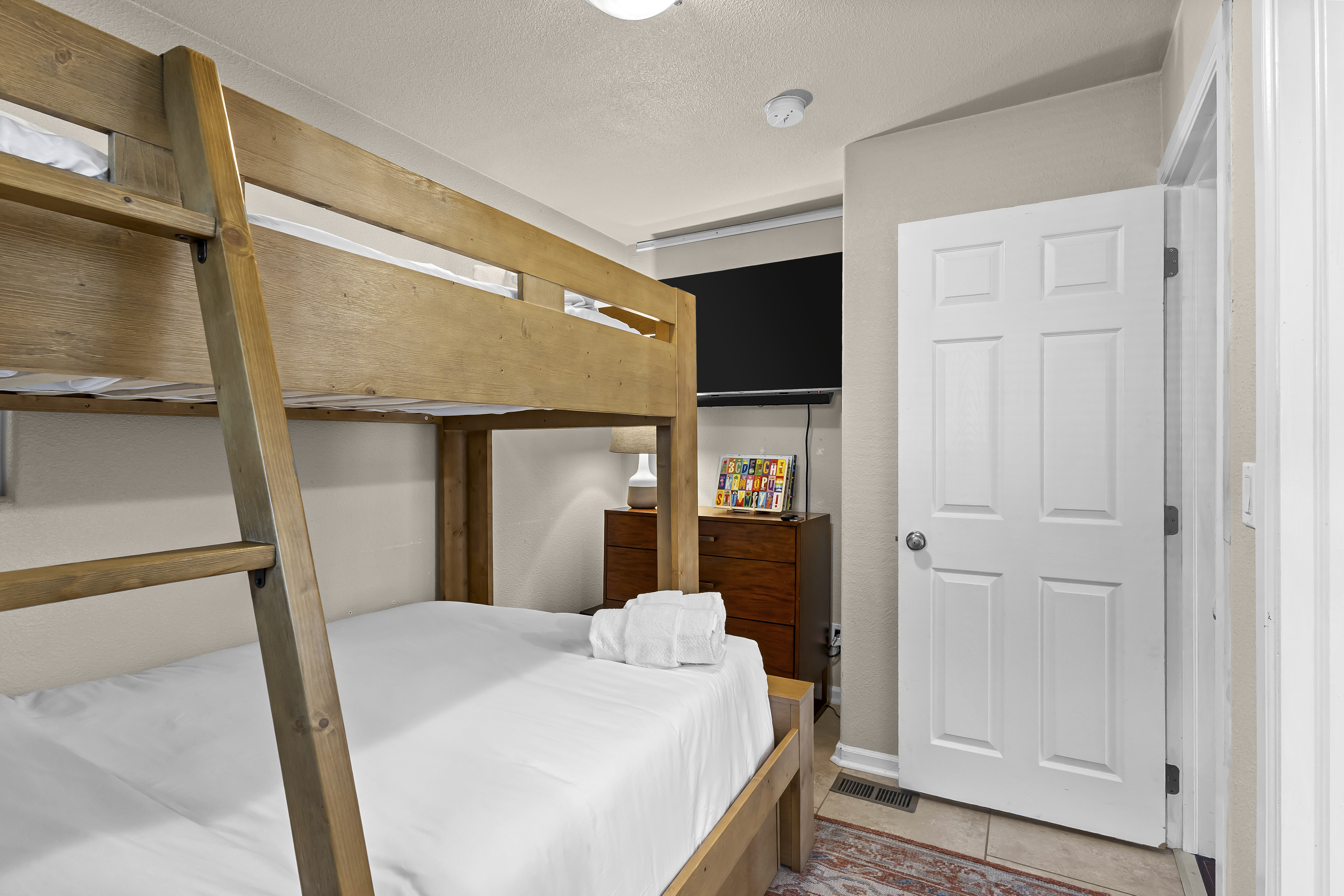 Guest bedroom with a twin-over-full bunk bed. 