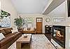 The living room includes a gas fireplace, a smart TV, and plenty of seating. 