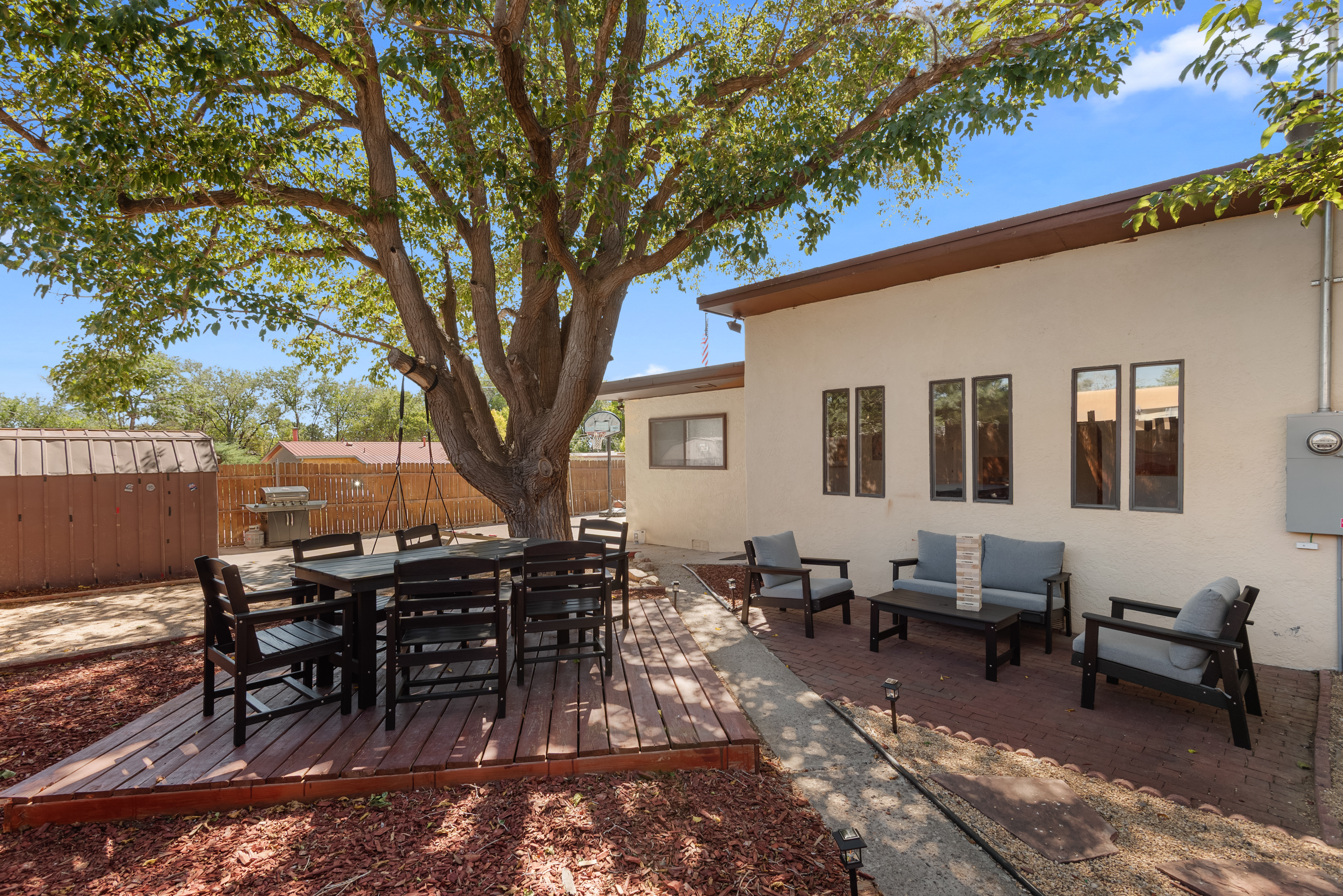 A fully fenced backyard with outdoor seating, a grill, hot tub, cornhole, and a basketball hoop! Plenty of space for your crew and your pets to roam.