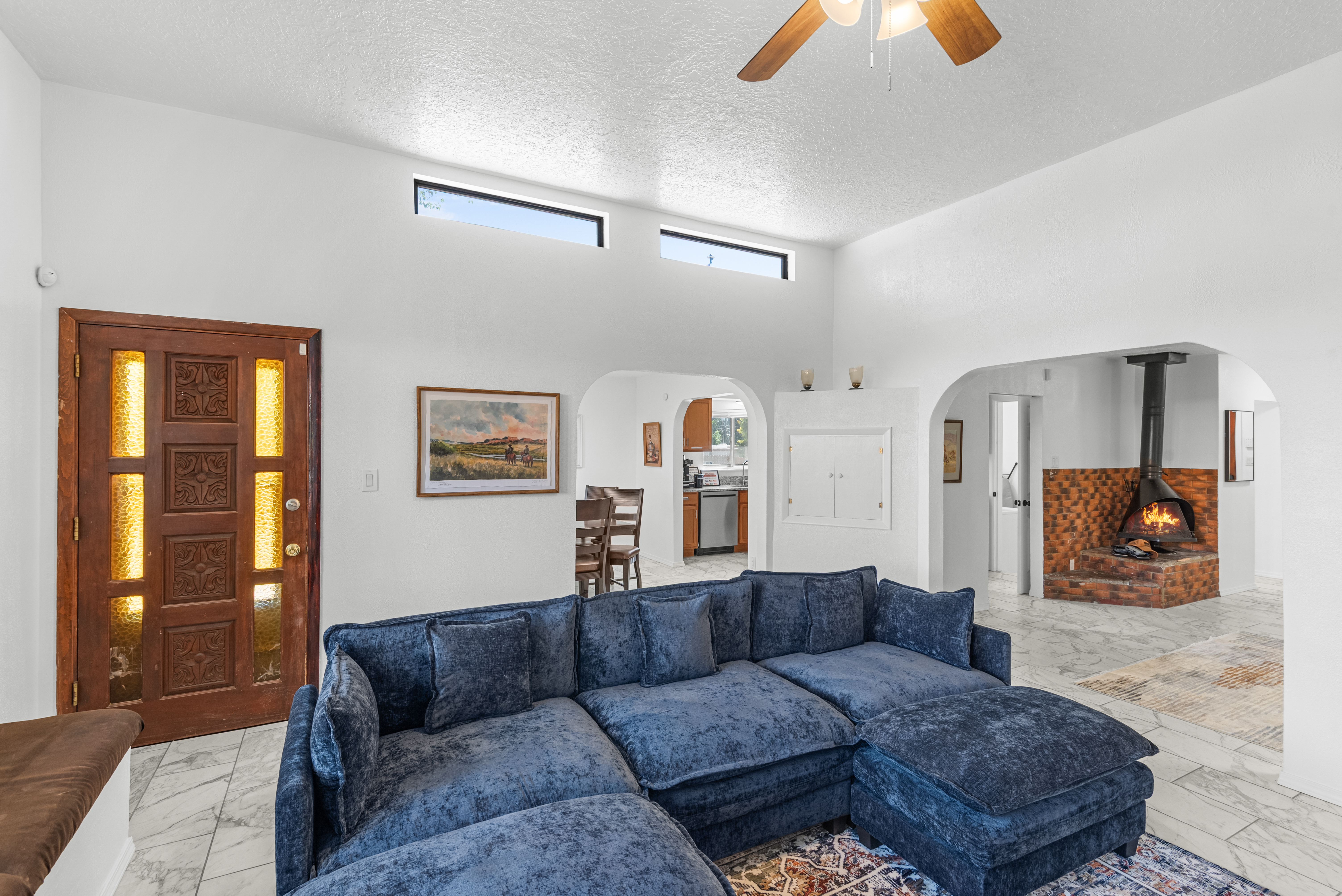 Spacious and inviting living room with a Smart TV, games, and a wood stove. The perfect spot to unwind after a day of adventure!