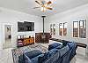 Spacious and inviting living room with a Smart TV, games, and a wood stove. The perfect spot to unwind after a day of adventure!