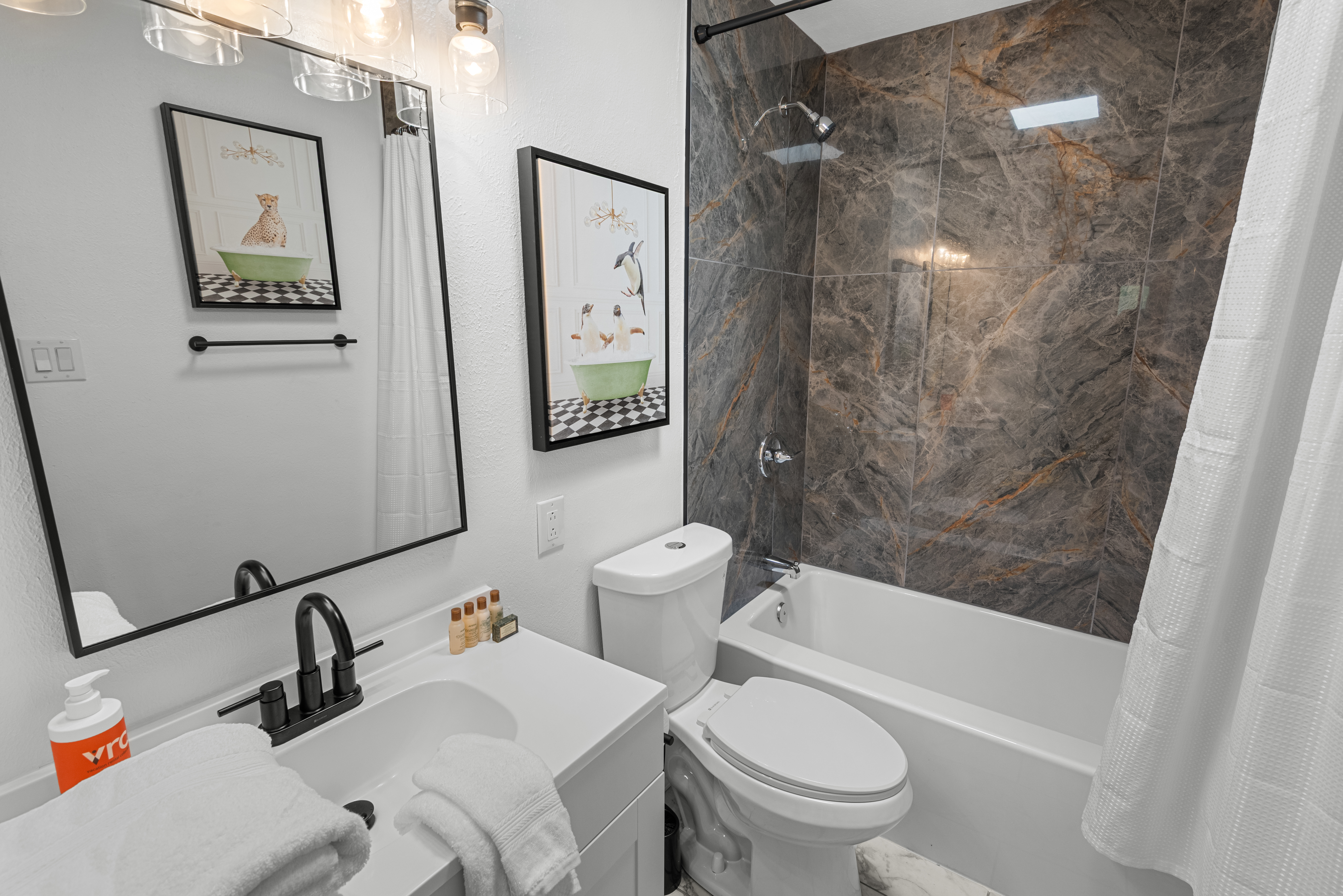 Full bathroom with convenient tub/shower combo and modern finishes.