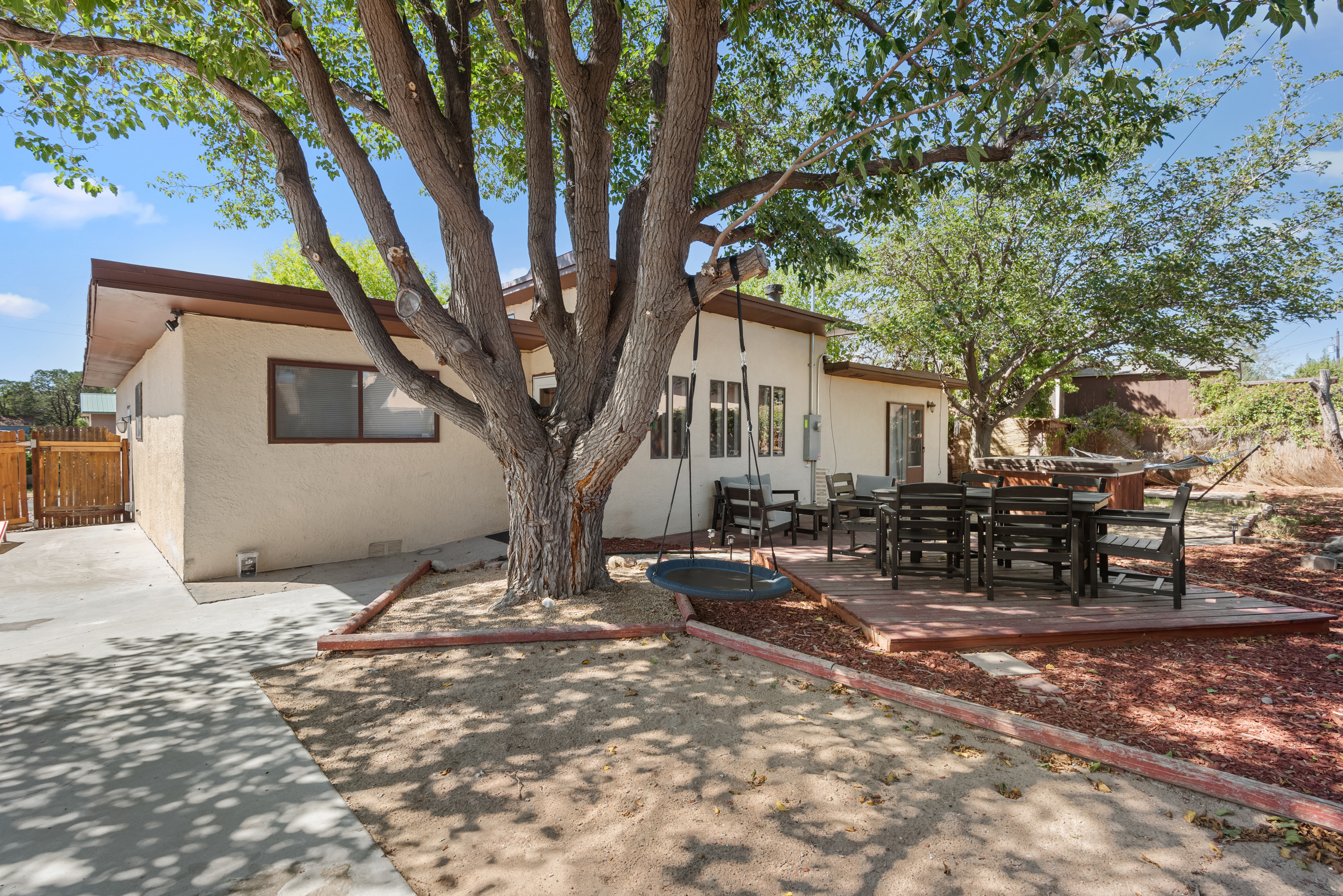 A fully fenced backyard with outdoor seating, a grill, hot tub, cornhole, and a basketball hoop! Plenty of space for your crew and your pets to roam.