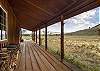 Our large, covered porch offers protection from the elements but stunning mountain views. 