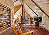 Our open loft offers comfort and relaxation with a futon, Smart TV and lots of books.
