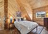Our second level open loft bedroom features a queen bed, mountain views and ensuite bathroom. 
