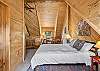 Our second level open loft bedroom features a queen bed, mountain views and ensuite bathroom. 