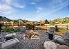 Our large, fenced back yard features a firepit, outdoor sitting area, private hot tub, covered patio and mountain views. 