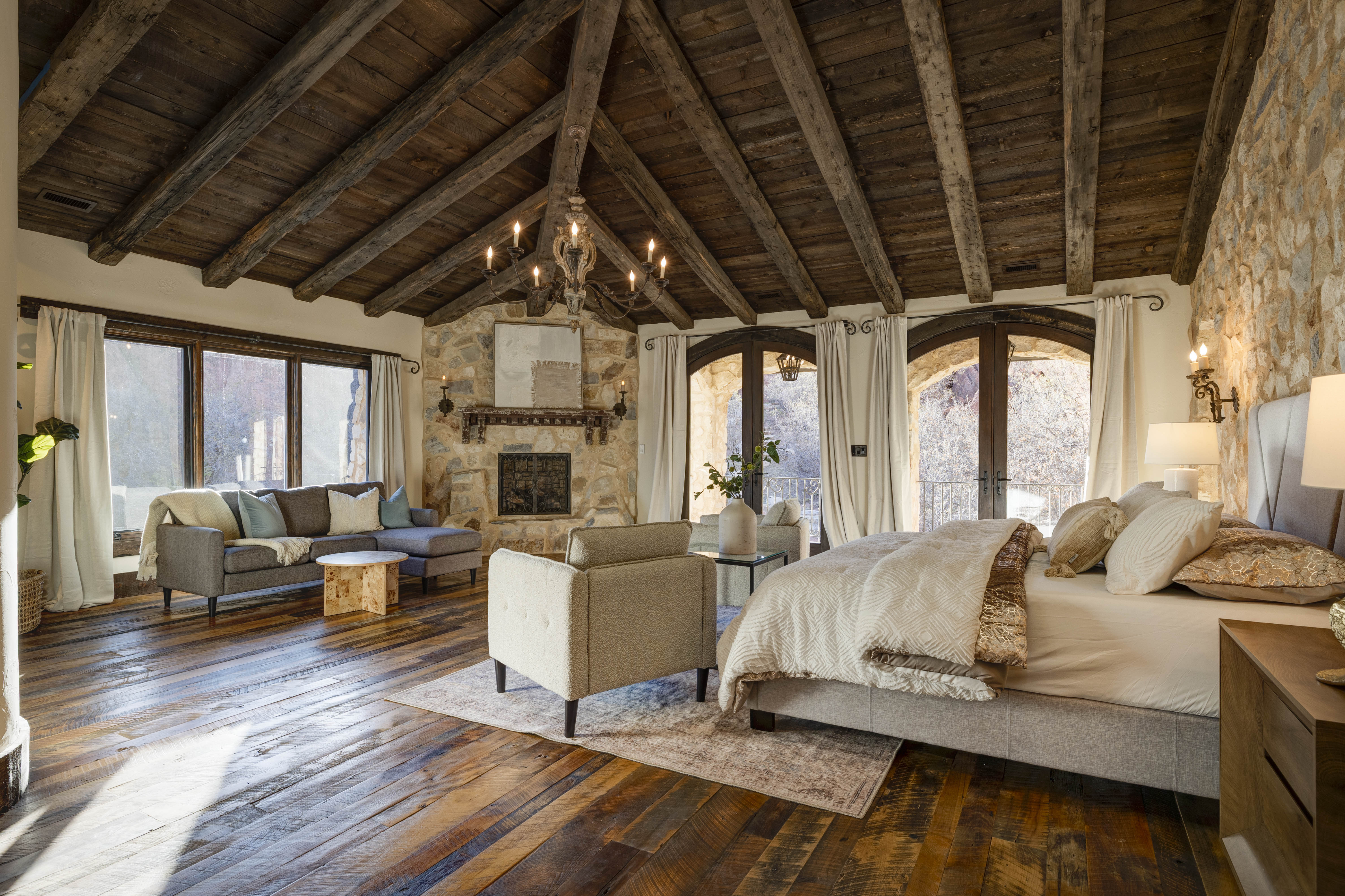 Your private retreat! The main king bedroom features soft linens, a lounge area, and a luxury en suite bathroom.