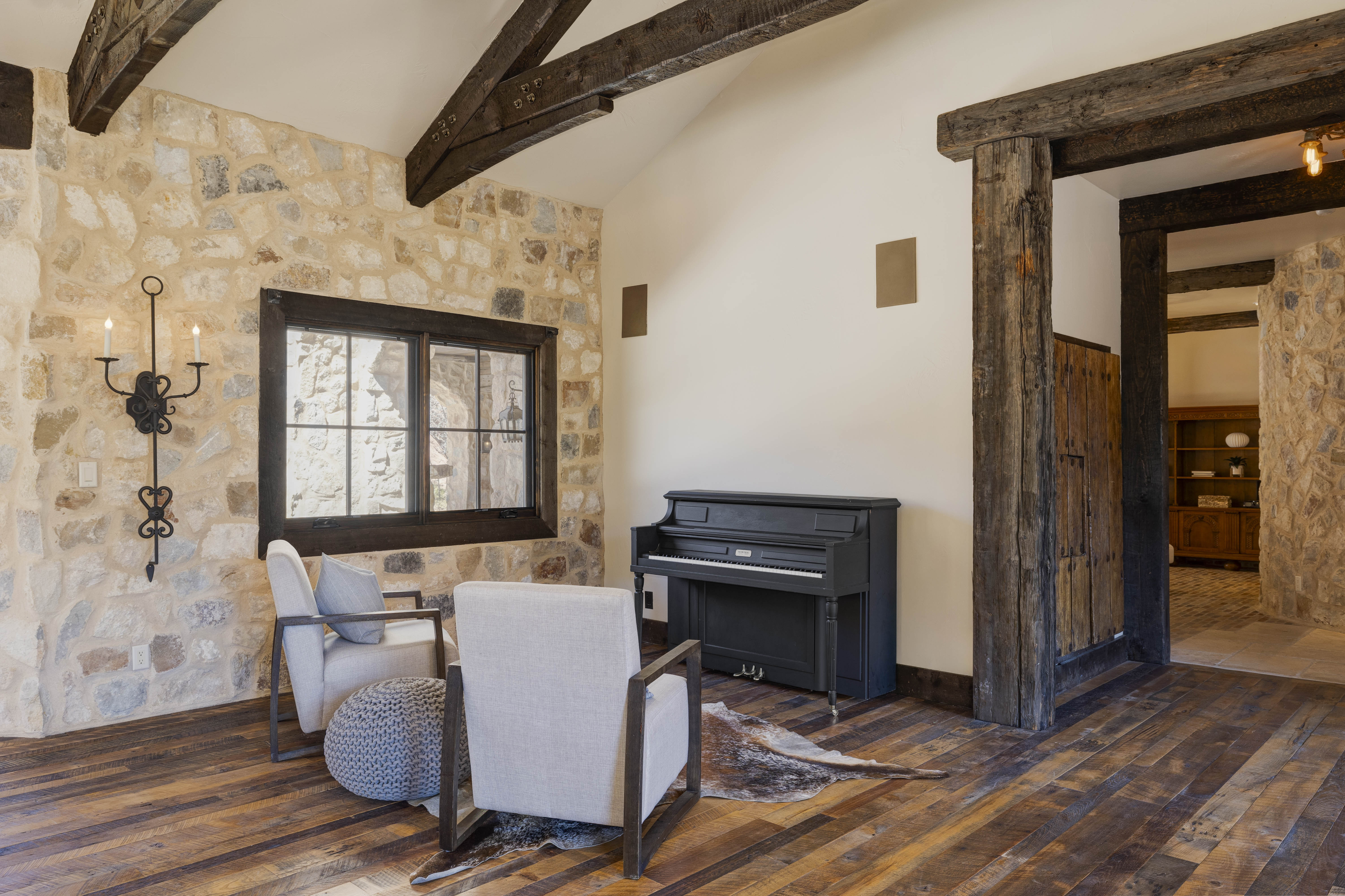 Sitting area with fireplace and piano.