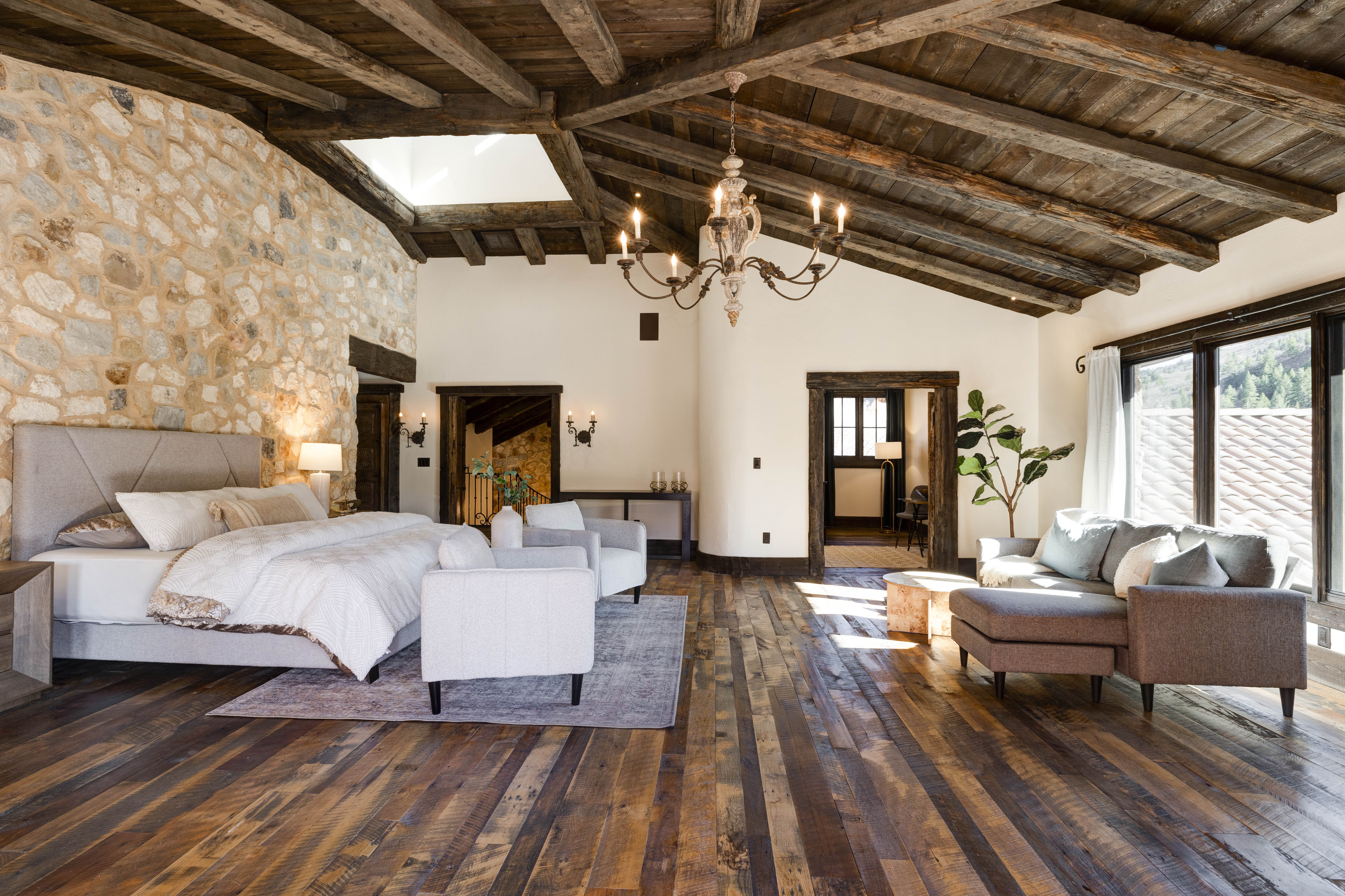 Your private retreat! The main king bedroom features soft linens, a lounge area, and a luxury en suite bathroom.
