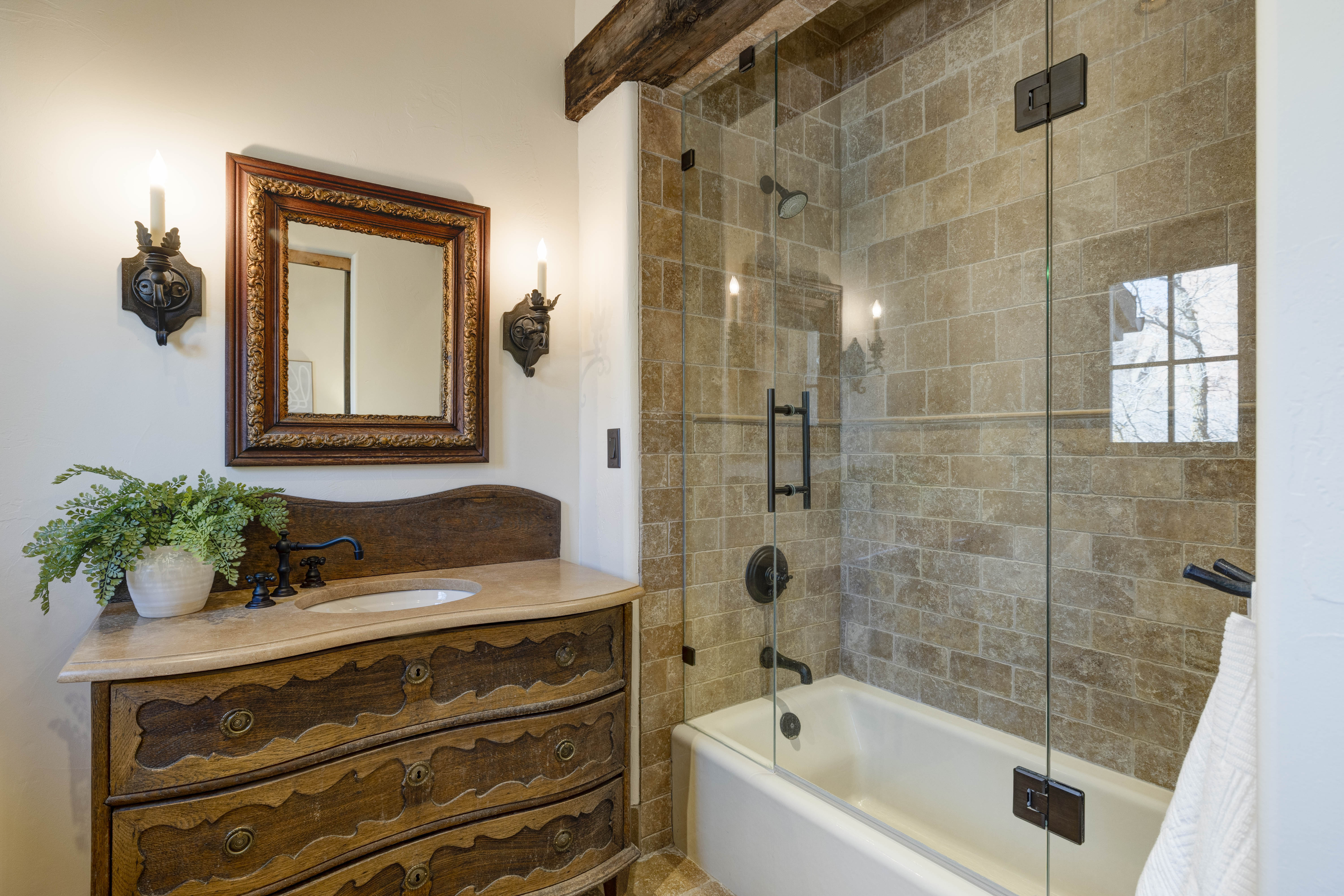 Spacious bathroom with tub and shower combo for added flexibility.