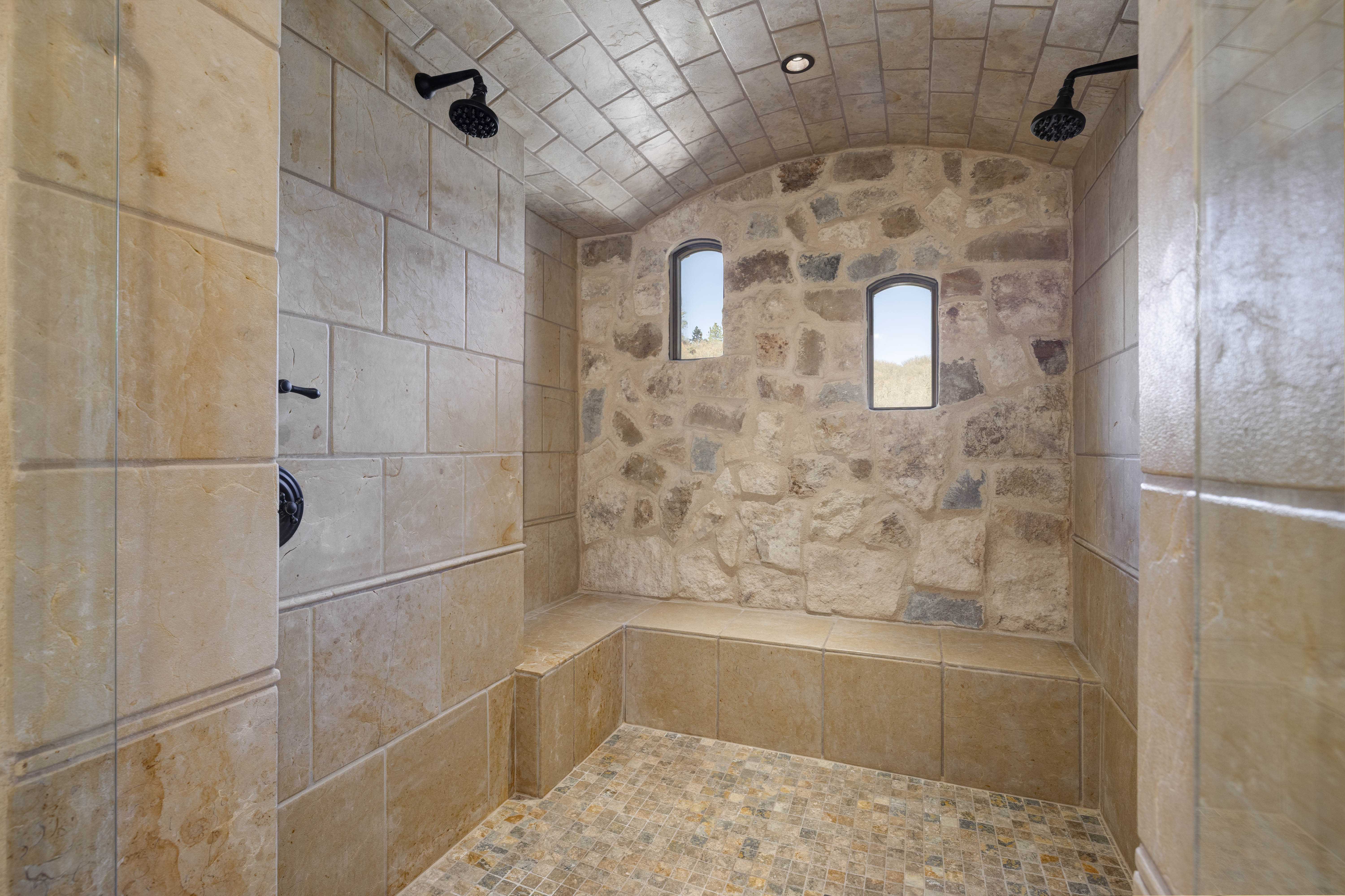 The luxury en suite bathroom includes a copper tub, large walk-in shower, and dual sinks. 