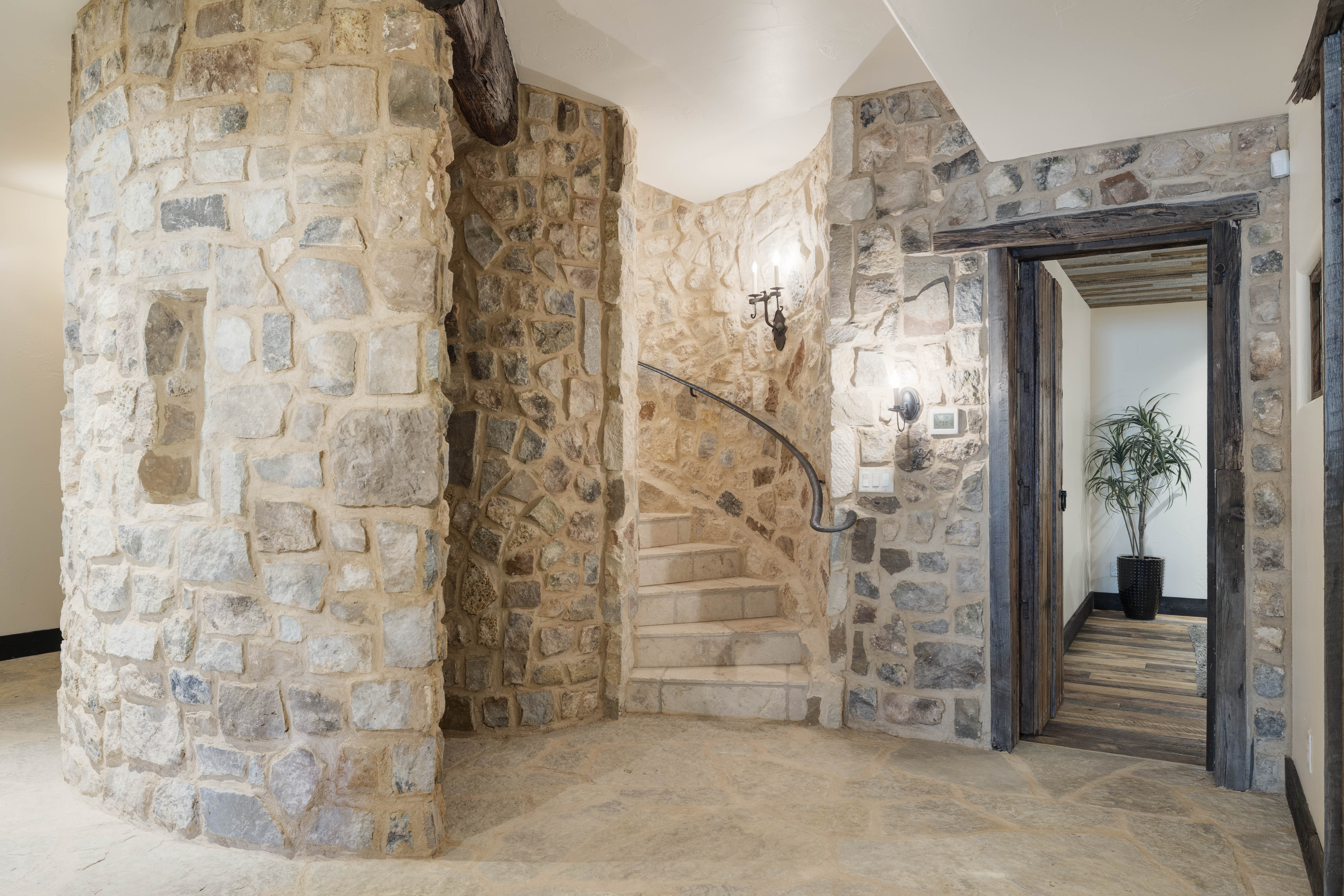 Beautiful stone stairwells are placed throughout the home. 