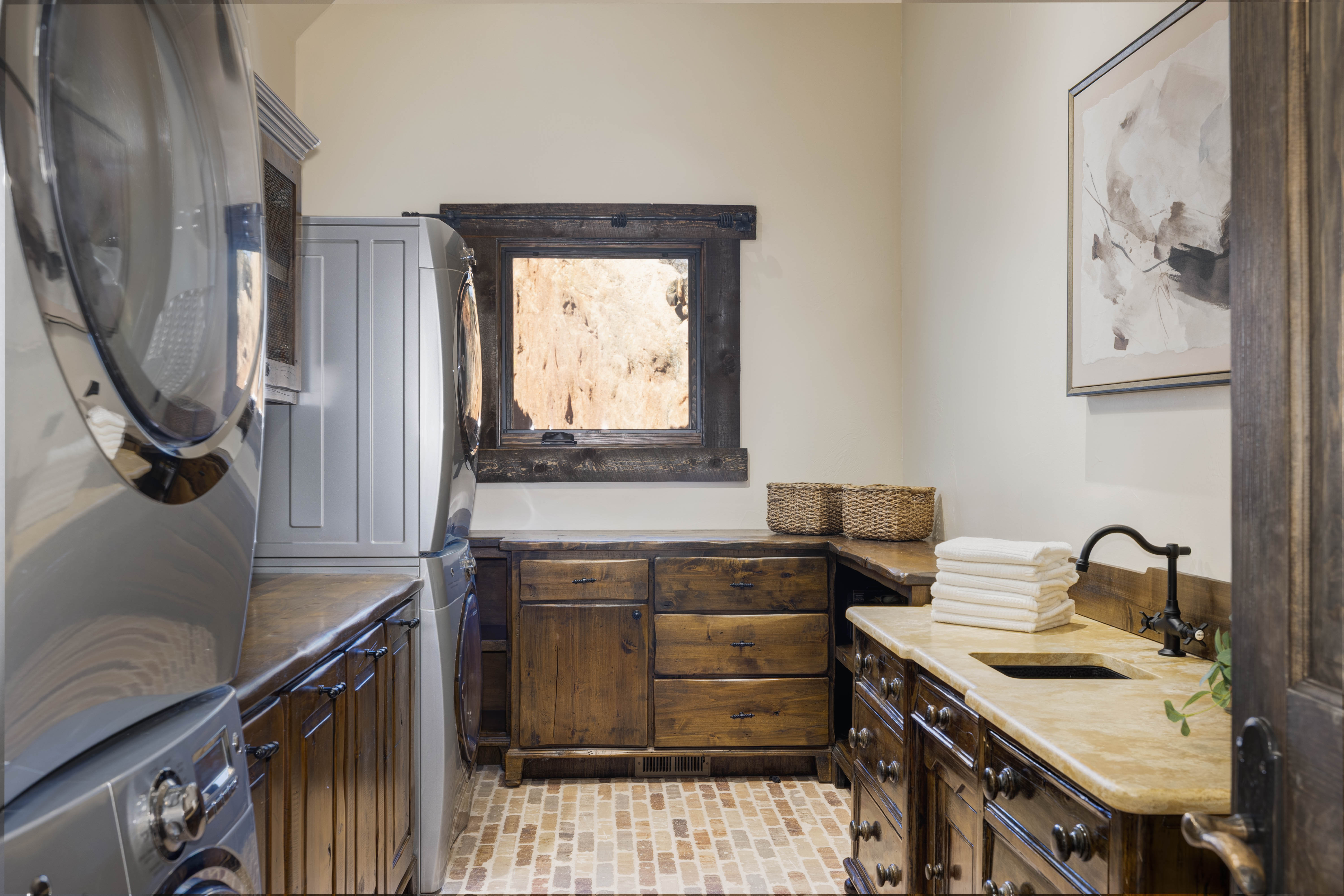 Laundry room space with dual washers and dryers. 