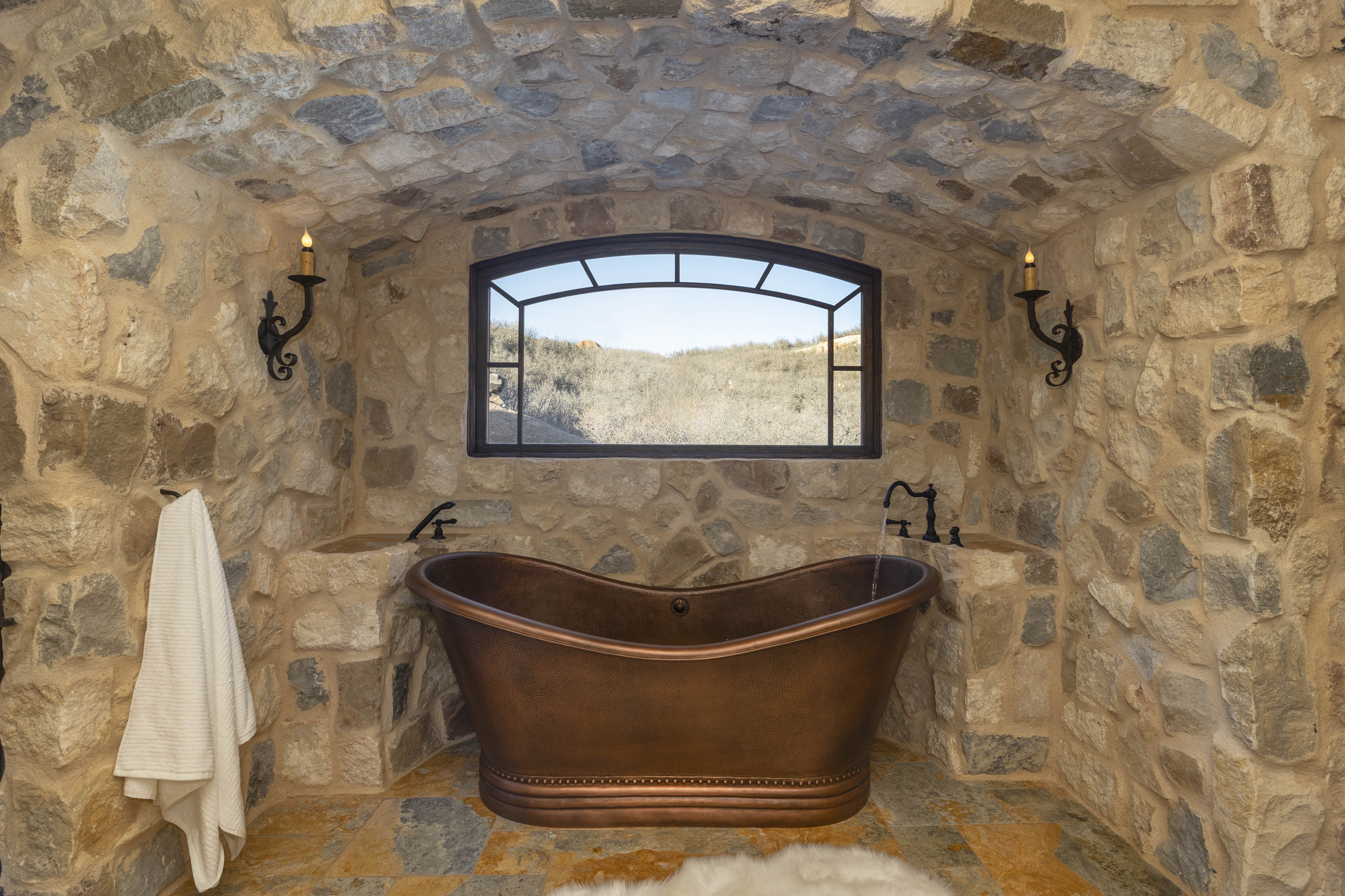 The luxury en suite bathroom includes a copper tub, large walk-in shower, and dual sinks. 