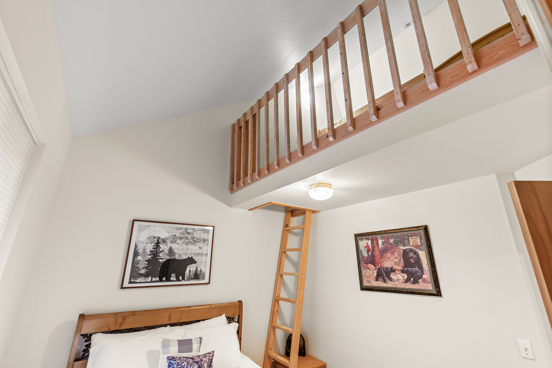 Queen Guest Bedroom #1 with a ladder to additional sleeping space in the loft