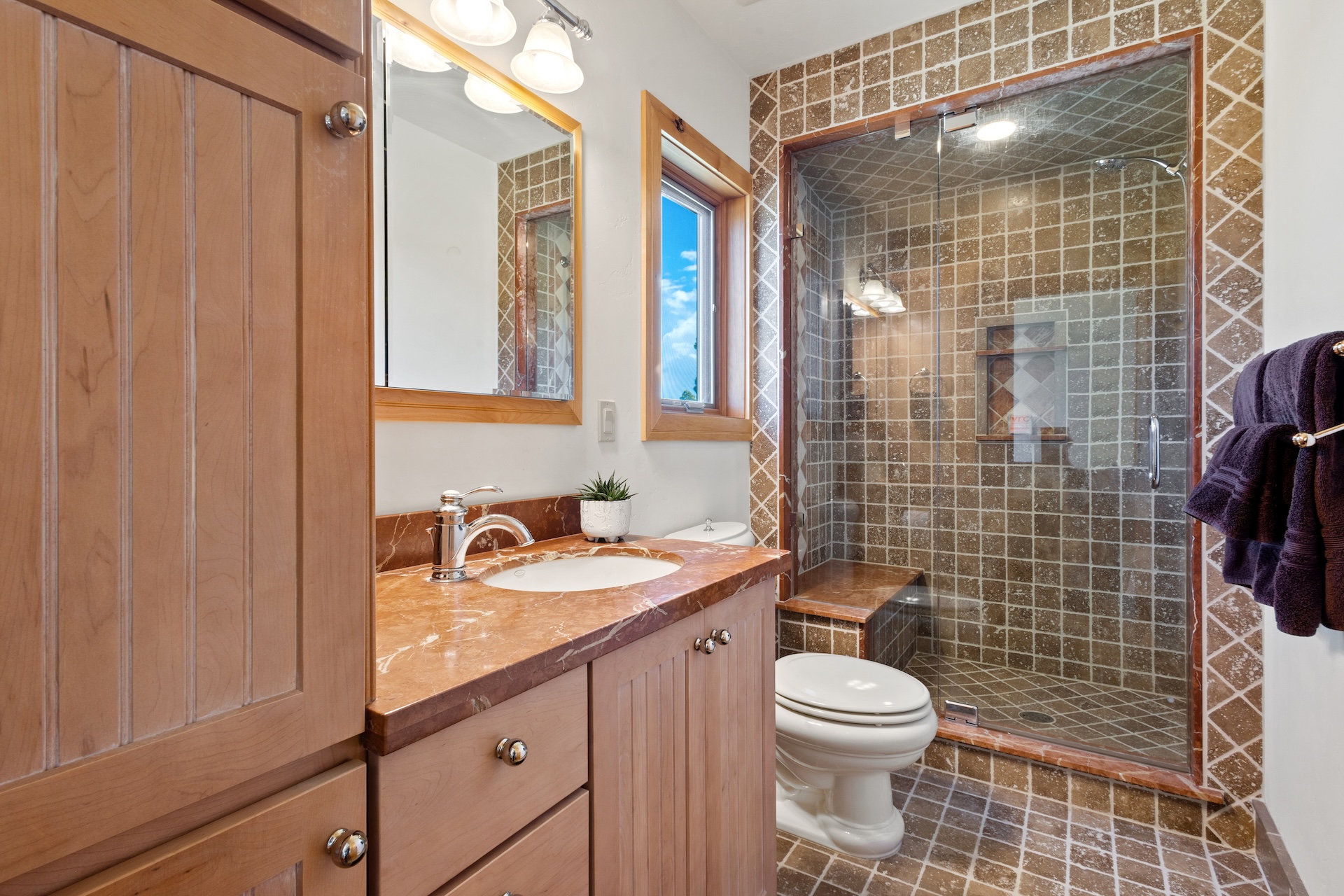 The private guest bathroom features a sleek, walk-in shower. 