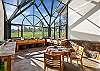 The all-glass greenhouse with a café table is the perfect spot to enjoy morning coffee or watch the stars.