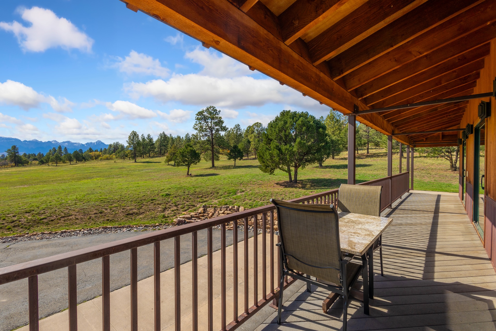The covered wrap-around deck is the perfect spot to enjoy a drink while soaking in the views.