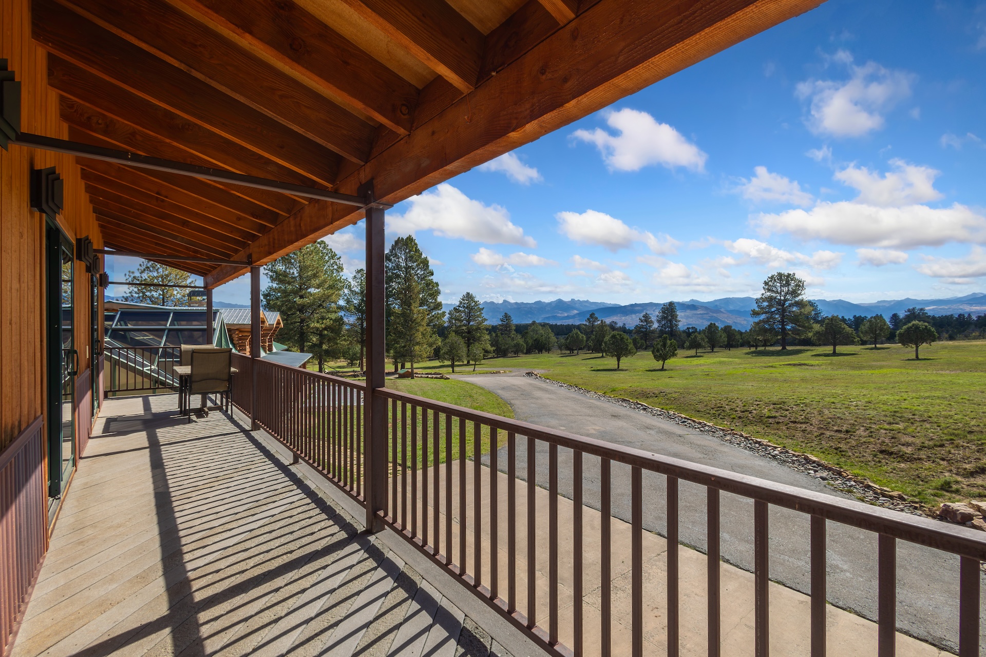 The covered wrap-around deck is the perfect spot to enjoy a drink while soaking in the views.