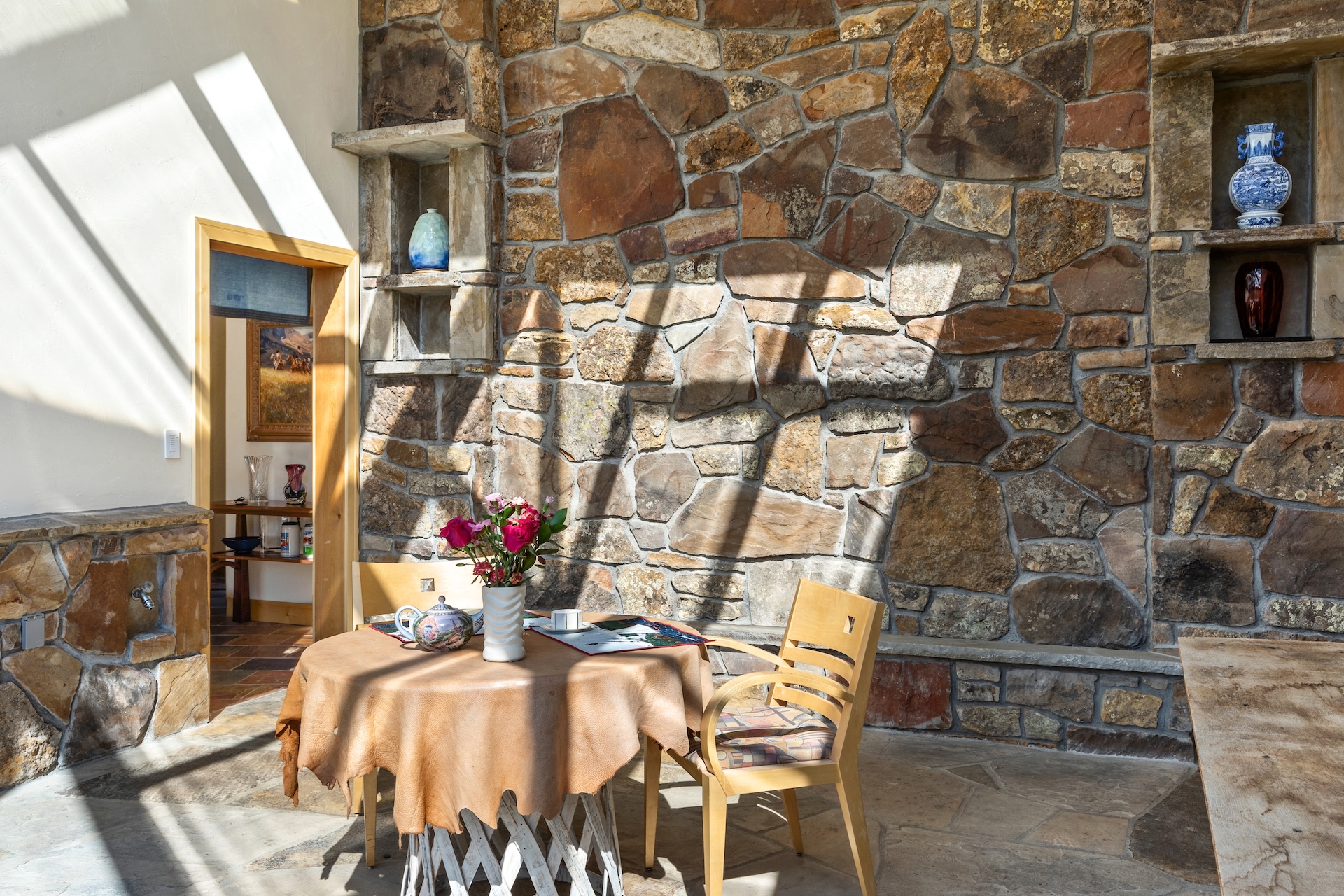 The all-glass greenhouse with a café table is the perfect spot to enjoy morning coffee or watch the stars.