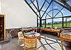 The all-glass greenhouse with a café table is the perfect spot to enjoy morning coffee or watch the stars.