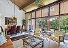 The large wall of windows in the open dining and living area fill the condo with natural light.