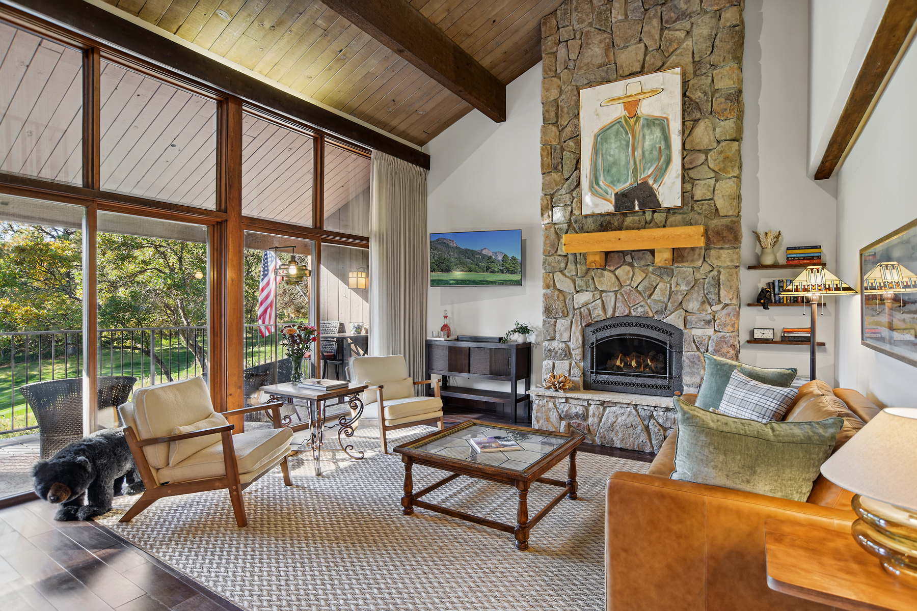 Comfortable living room with electric fireplace and smart TV – large windows fill the room with light!