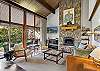 Comfortable living room with gas fireplace and smart TV – large windows fill the room with light!
