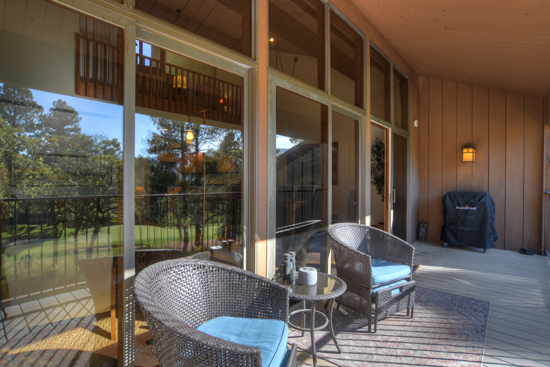 Deck with outdoor seating, electric Blackstone griddle, and golf course views.